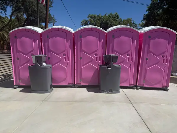 Pink event porta potties with hand-wash stations