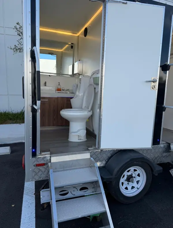 Restroom trailer door open with fold-down steps