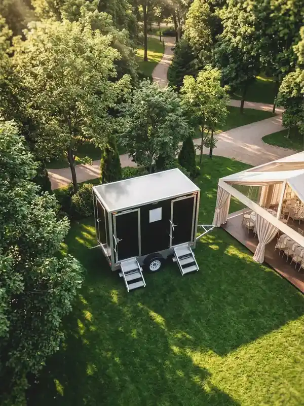 Restroom trailer on a lawn at a wedding