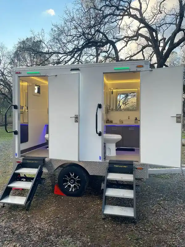 Two-stall restroom trailer with lit interiors